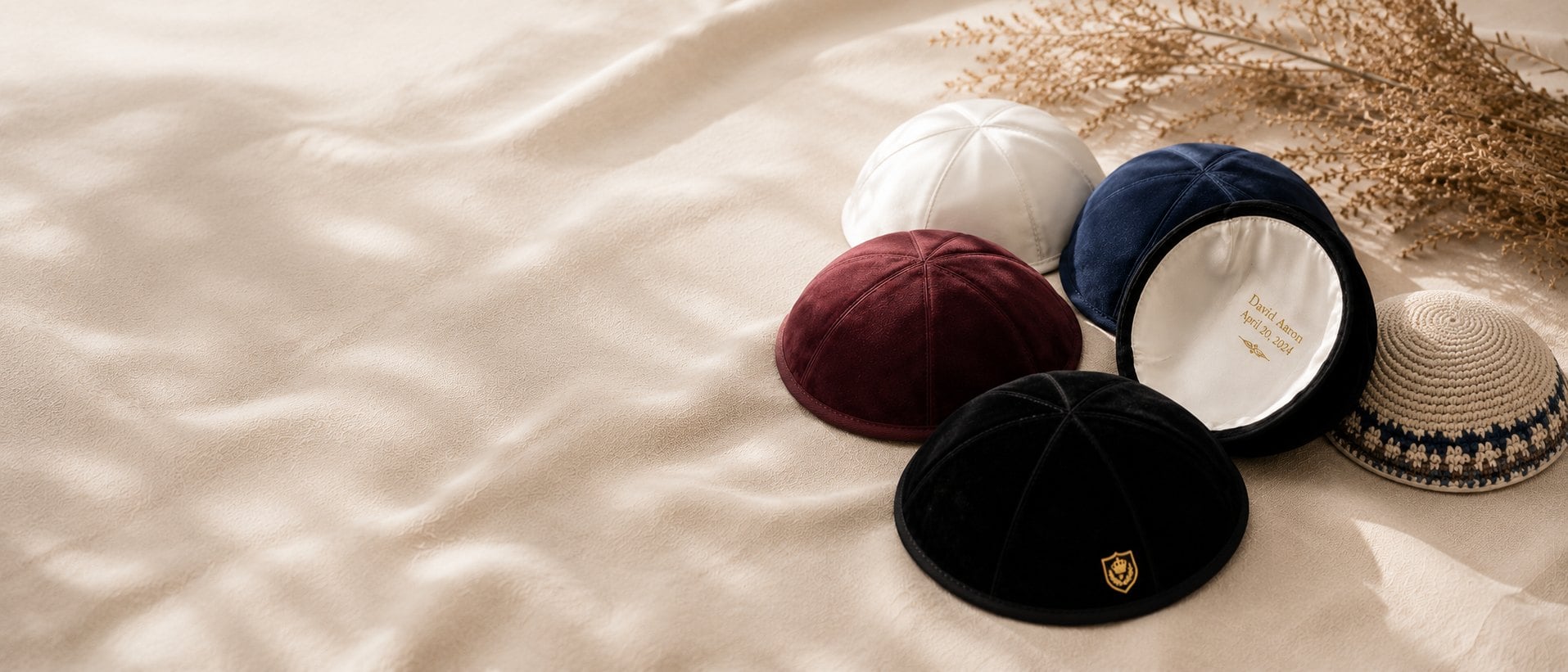 Custom satin and suede kippahs personalized with foil-stamped names and dates