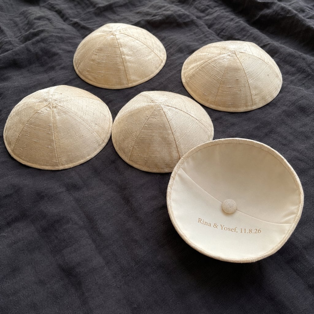 Custom raw silk kippahs with a couple’s names stamped in gold inside